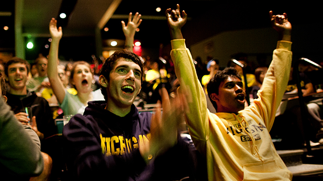 Students cheering in Michigan gear