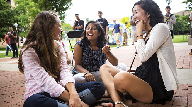 Students chatting and laughing on campus