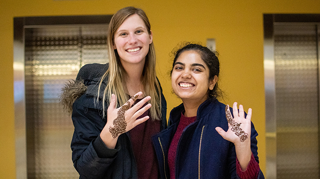 Students at Diwali celebration with henna