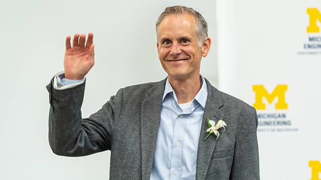 cProf. Phillips raising his hand in acknowledgement at the awards ceremony