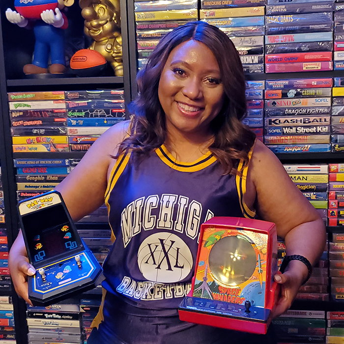 Linda Guillory in front of her video game collection
