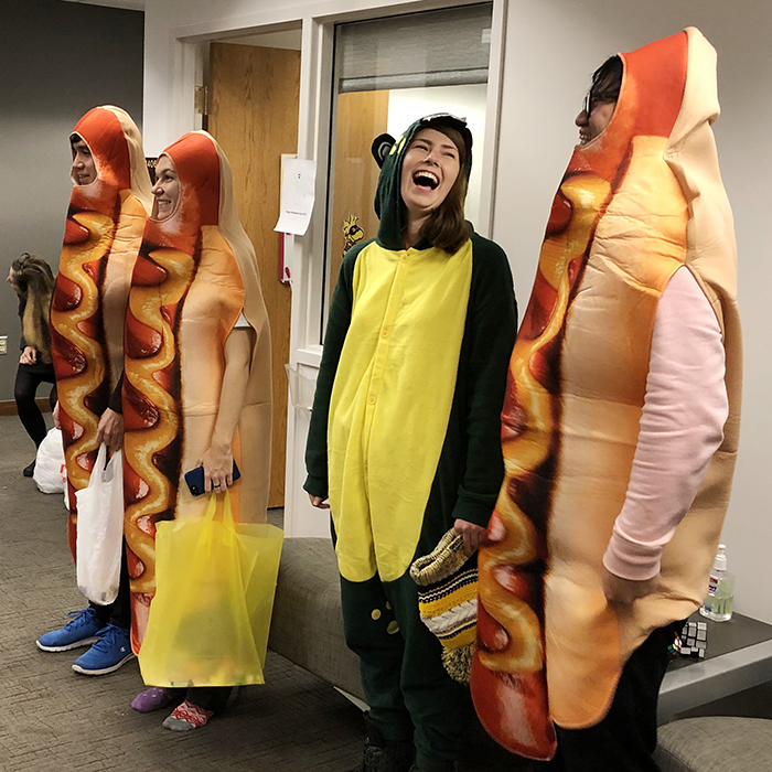 students in hot dog and dinosaur halloween costumes